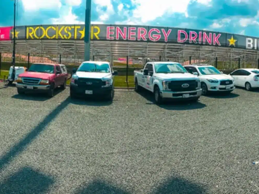 A row of cars parked in front of a building.