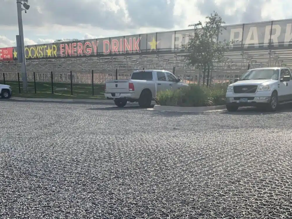 A truck parked in the parking lot of an industrial building.