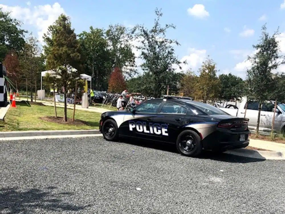 A police car is parked on the side of the road.